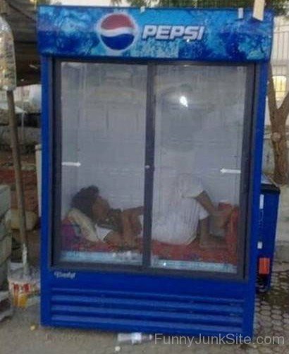 Man Sleeping In Cool Refrigrator